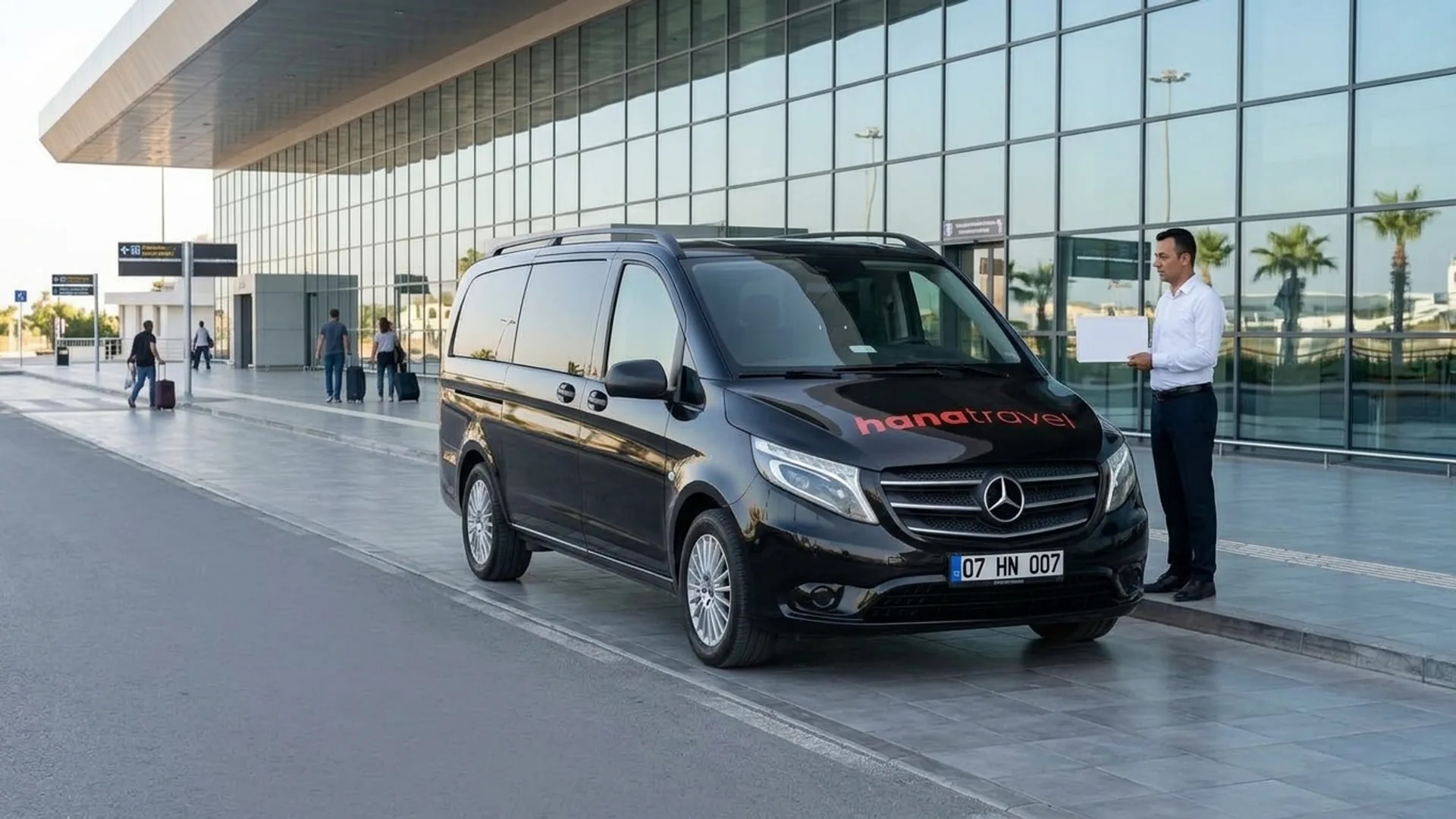 Your driver is waiting outside arrivals Hana Travel driver holding a name board beside the black Vito outside Antalya Airport arrivals for a Kundu airport transfer